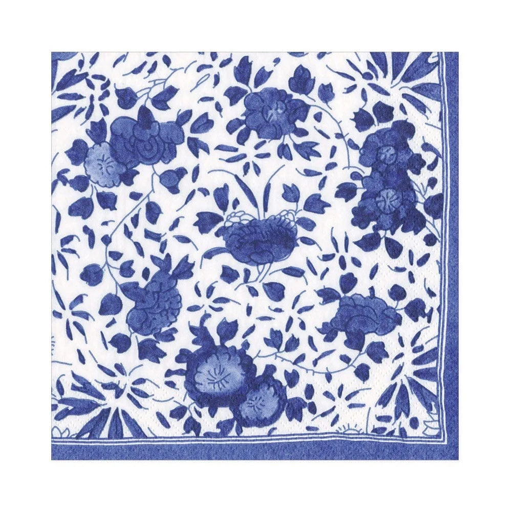 Part of Caspari's Delft Blue Collection, this square textile features a blue and white floral pattern with stylized flowers and leaves and a geometric border—crafted from biodegradable materials for an eco-friendly touch.