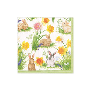 Caspari’s Bunnies and Daffodils Place Setting Collection napkin features five rabbits amid yellow, orange, and pink flowers with green grass and a light green border—ideal for Easter table decor.