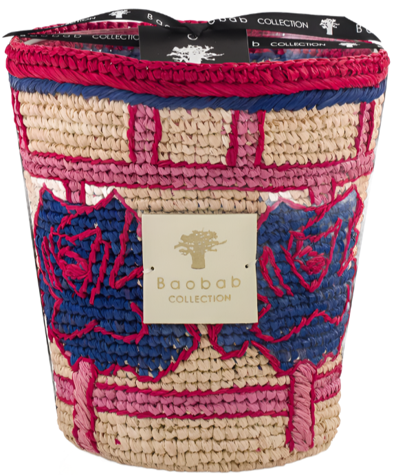 A colorful Baobab Collection Frida Draozy Frida scented candle with a woven basket design in beige, blue, and pink, featuring a metallic logo plate on the front.