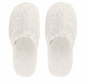 The Egoist Bath Slippers by Graccioza are white, fuzzy, closed-toe slippers crafted from high-density Egyptian cotton and viewed from above on a plain background.