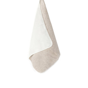 The Bicolore Bath Collection towel by Graciozza, in beige and white, hangs against a plain white background, elegantly showcasing both reversible sides.