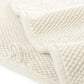 Close-up of folded beige Graccioza Pearls Bath Collection fabric, featuring an ultra-soft, absorbent texture and a sewn-in loop.