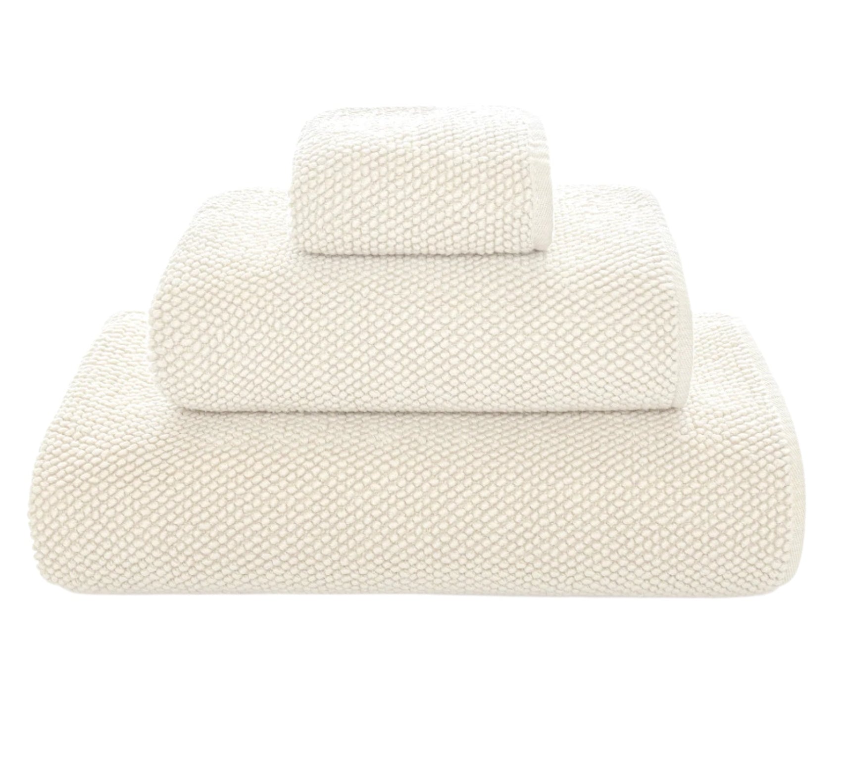 Three folded white towels from Graccioza's Pearls Bath Collection, stacked in descending size order, highlight their ultra-soft and absorbent texture against a plain white background.