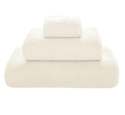 Three folded white towels from Graccioza's Pearls Bath Collection, stacked in descending size order, highlight their ultra-soft and absorbent texture against a plain white background.