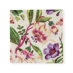 The Caspari Porcelain Blooms Collection eco-friendly square paper napkin features a botanical print with pink, purple, and cream flowers, green leaves, and a butterfly on a white background.