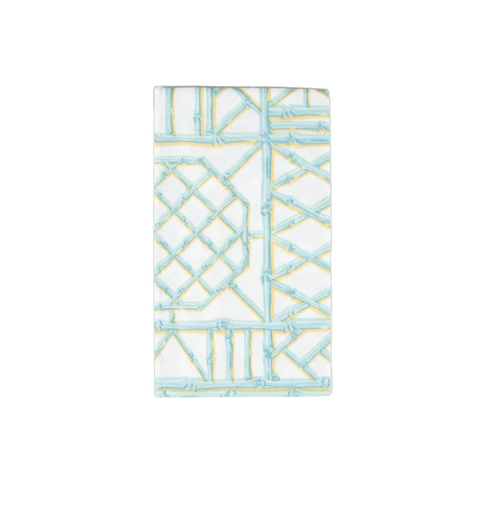 The Bamboo Screen Collection by Caspari features rectangular ceramic tiles with a raised bamboo-inspired pattern in light blue and yellow on white, ideal to pair with biodegradable paper linen napkins for eco-friendly decor.