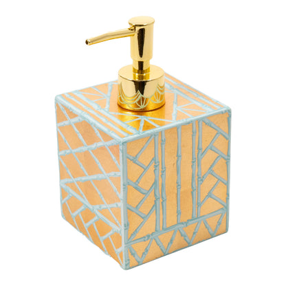 The Caspari Bamboo Screen Robin's Egg Bath Collection features a square soap dispenser with a gold pump and geometric gold and light blue pattern, handcrafted in Vietnam using traditional lacquerware techniques. Photographed on a white background.