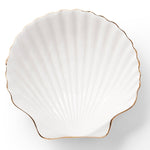 The Shell Appetizer Plate by Aerin is a white ceramic scallop shell dish with elegant gold edging, shown on a white background—an ideal choice for bringing coastal style to your table.