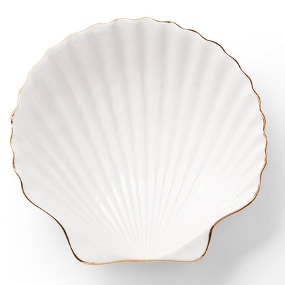 The Shell Appetizer Plate by Aerin is a white ceramic scallop shell dish with elegant gold edging, shown on a white background—an ideal choice for bringing coastal style to your table.