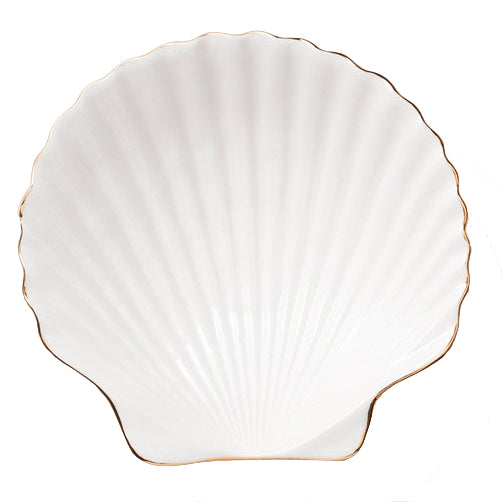 The Aerin Shell Appetizer Plate is a white ceramic plate with a scallop shell shape, ridged surface, and thin gold trim—an elegant way to bring coastal style to your table.