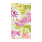 The Orchid Conservatory Collection towel by Caspari is a rectangular white piece adorned with a pink, yellow, and green orchid floral pattern—ideal for enhancing table settings or complementing party supplies.