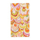 The Marbled Ceramica Collection by Caspari features a rectangular rug with a colorful, scalloped pattern of yellow, orange, pink, green, and white marbled waves on a white background.