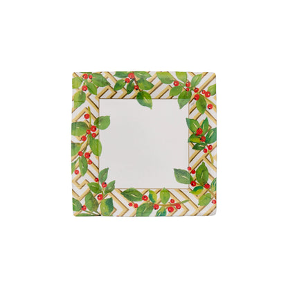 The Caspari Holly and Fretwork White Napkin and Tabletop Collection features square ceramic plates with a geometric gold and white border plus green leaves and red berries, adding elegance to festive gatherings when paired with decorative tableware.