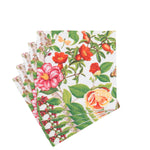 A stack of Caspari's Christmas Chinoiserie White Collection paper napkins featuring festive floral patterns, perfect to pair with elegant plates for a charming disposable tableware set.