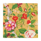 The Caspari Christmas Chinoiserie Gold Collection napkin features festive florals, green leaves, a yellow-green bird, berries, and butterflies on yellow—ideal for pairing with elegant tableware or paper dinnerware at your next gathering.