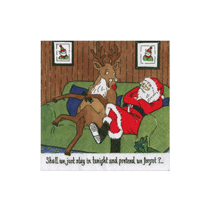 Santa Claus and a reindeer sit on a green couch amid Christmas décor and party supplies. Below, the Caspari Santa At Home Cocktail Napkin reads: "Shall we just stay in tonight and pretend we forgot P...?.