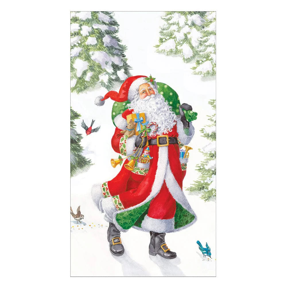 Woodland Santa from Caspari’s Woodland Santa Collection carries a green sack filled with gifts and festive Caspari paper plates as he walks through a snowy pine forest with birds nearby, ready to celebrate.