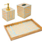 The Caspari Bamboo Screen Robin's Egg Bath Collection is a handcrafted bathroom set from Vietnam, featuring gold and blue geometric lacquerware, including a soap dispenser, tissue box cover, and rectangular tray.