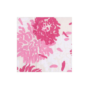 Caspari’s Chrysanthemum Raspberry Collection napkins feature a white background with large pink floral designs; these triple-ply, eco-friendly napkins offer both style and sustainability.