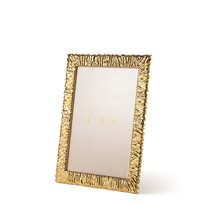 A gold, textured Ambroise Frame from Aerin stands upright on a white background, showcasing a placeholder insert labeled "AERIN" in gold text.