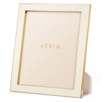 The Cream Classic Shagreen Frame Collection by Aerin features a textured, gold-edged embossed frame that stands upright—a refined way to display your photos.