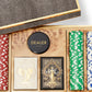 The Aerin Shagreen Poker Set, Chocolate, features multicolored chips, two card decks, and a dealer marker, all stylishly housed in an elegant chocolate shagreen wooden case with a textured lid.