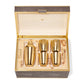 The Aerin Chocolate Classic Shagreen Bar Set features a gold-toned cocktail shaker and three matching cups in a beige, suede-lined shagreen box with a hinged lid—an elegant addition to any home bar.