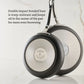 Two stainless steel frying pans from the Hestan TITUM® Fusion Collection are shown bottom side up, highlighting their brand name and diamond-reinforced cookware bases.