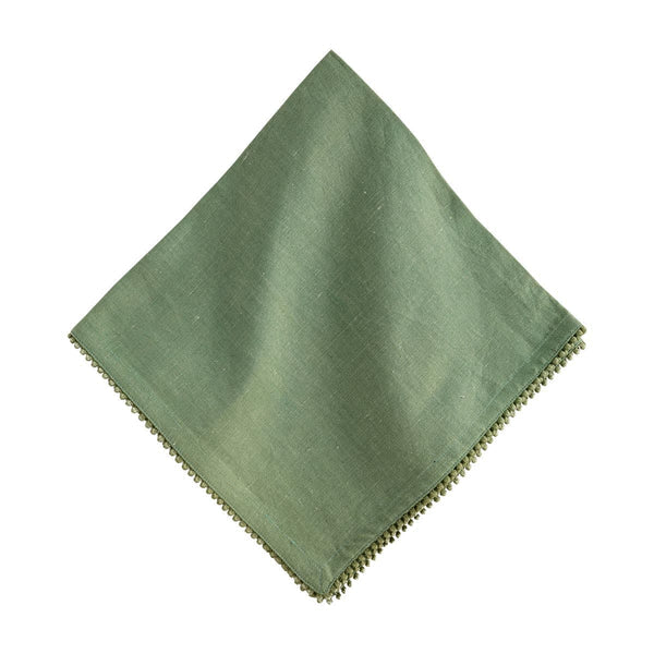 The Juliska Berry Trim Napkin Collection features a green woven cotton napkin with subtle texture, shown folded on a white background and finished with an embroidered decorative trim along the edge.