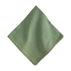The Juliska Berry Trim Napkin Collection features a green woven cotton napkin with subtle texture, shown folded on a white background and finished with an embroidered decorative trim along the edge.