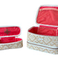 Two beige and white zippered pouches from the Stephanie Johnson Paros Coconut Travel Collection, both open to show pink interiors: one is a rectangular Mae Mini Pouch, the other a smaller cylindrical Jenny Train Case.