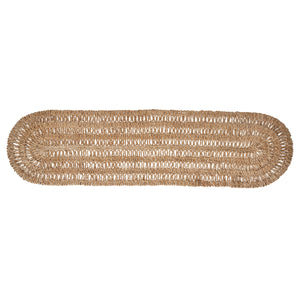 The Juliska Straw Loop Natural Table Runner features an oval shape and open, airy light brown weave, creating the perfect foundation for an elegant tablescape or as natural table decor on a white background.