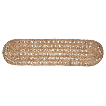 The Juliska Straw Loop Natural Table Runner features an oval shape and open, airy light brown weave, creating the perfect foundation for an elegant tablescape or as natural table decor on a white background.