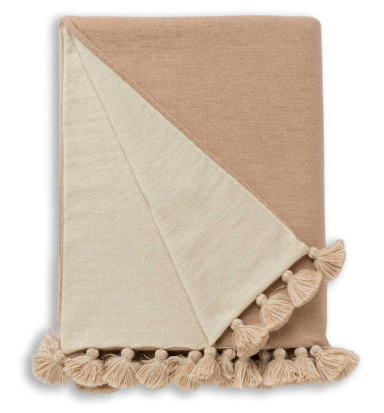 The Alicia Adams Alpaca Bali Throw in beige/ivory, made from hypoallergenic alpaca wool and featuring tassels, is displayed against a white background.