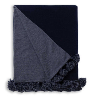 The Alicia Adams Alpaca Bali Throw in Navy/Denim Blue features folded alpaca wool with tassel edging on a white background—ideal for luxury throw lovers and sustainable home decor enthusiasts.