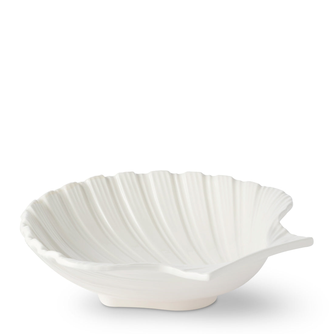 The Aerin Cream Shell Platter Collection features white earthenware ceramic dishes shaped like seashells, perfect as serving platters for adding coastal style to your table. Shown on a plain white background.