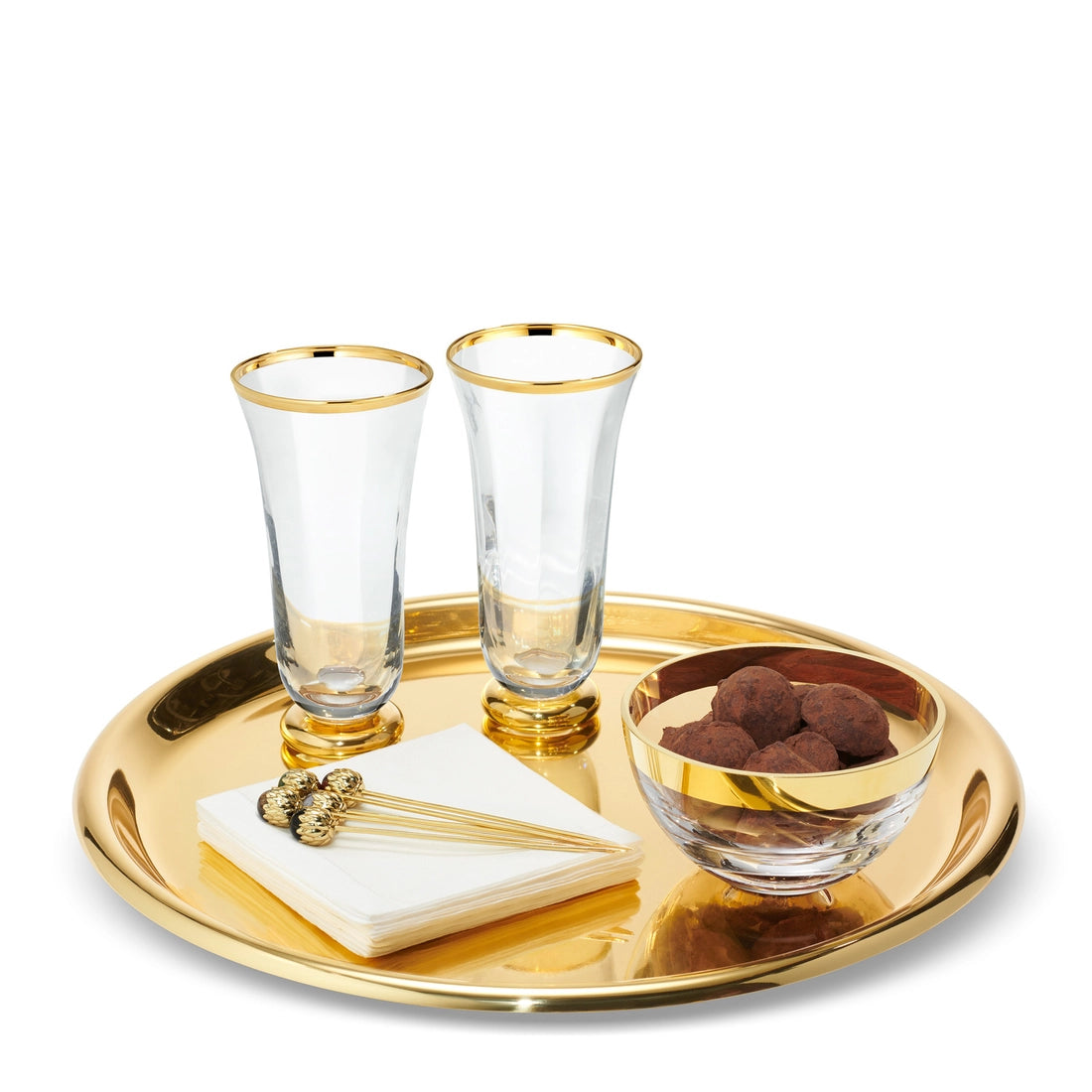 Aerin Mariza Tray holding two tall glasses, a small glass bowl filled with truffles, a stack of white napkins, and gold cocktail picks.
