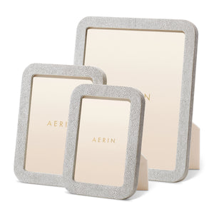 Three rectangular Modern Shagreen Frames by Aerin, each in a different size with a textured finish and beige backing, are displayed upright to showcase their contemporary style.