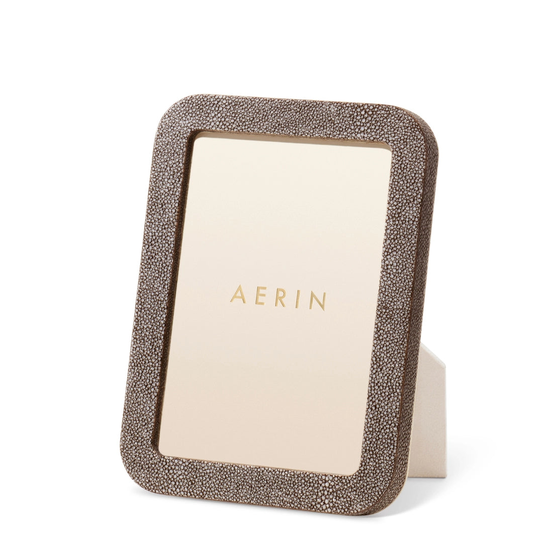 Aerin's Modern Shagreen Frame features a textured brown border and includes a placeholder insert with the brand name, displayed upright.