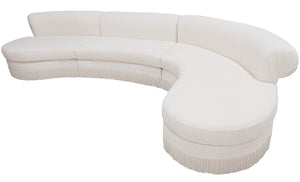 A large, white, crescent-shaped **Curved Sectional** sofa by **LEE PARKER** with a textured Idaho Cream fabric and fringe detailing at the bottom, perfect for adding a touch of elegance to any living space.