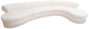 A white Curved Sectional by LEE PARKER in Idaho Cream with three seat cushions and low, rounded backrests. The bottom edge features a subtle fringe detailing, evoking the sophisticated charm showcased at the Kips Bay Show House.