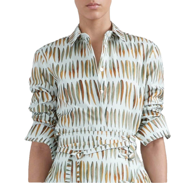 Woman wearing an Altuzarra Chika Top with ruffle sleeves and a belted waist, featuring a white and brown brushed leaves design.