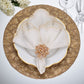 A gold and white table setting highlights a fan-folded Kim Seybert Lune Napkin, secured with a jeweled napkin ring and displayed on a gold charger plate.