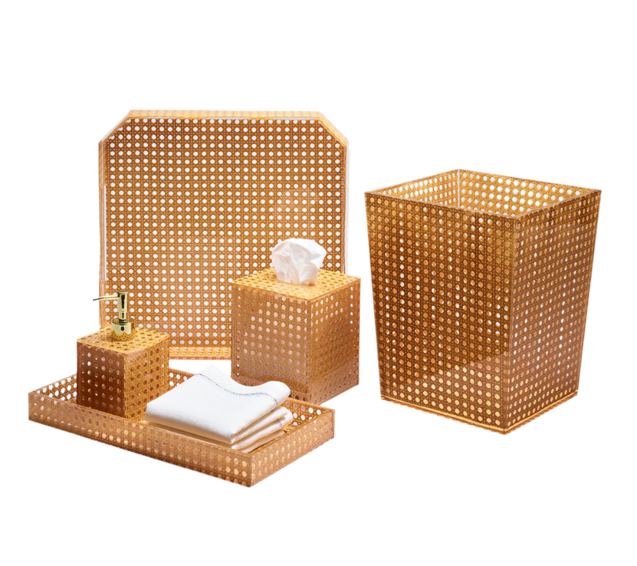 The Kim Seybert Natural Reed Bath Collection features gold-colored bathroom accessories with a natural wicker cane design, including a pump dispenser tray, towels, tissue box cover, wastebasket, and a raised-edge tray for stylish decor.