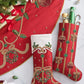 Two red Jewel Wreath Stocking, Red, Green & Gold stockings and a matching tree skirt, all decorated with intricate beadwork of wreaths, holly, and ornaments.