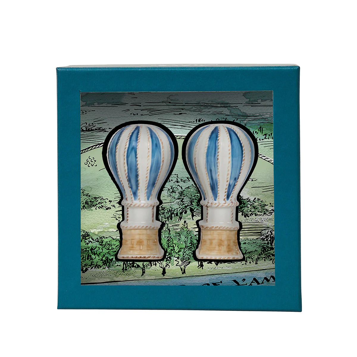 The L'Amour Toujours Hot Air Balloon Salt and Pepper Shaker Set by Juliska features hand-painted blue and white ceramic shakers in a teal Juliska gift box with a scenic background illustration.