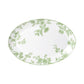 The Bernardaud Albertine Collection features an oval white ceramic plate with scalloped edges, a green floral pattern, and a green-edged rim, displayed on a white background.