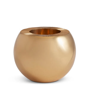 Aerin’s Sphere Match Striker features a round, metallic gold design with a glossy finish and subtle ridged details at the rim, capturing the refined artistry of sand cast craftsmanship.
