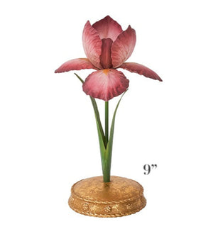 From the Meadow Walk Iris Candle Holder Collection by Juliska, this 9-inch candle holder showcases a hand-painted purple iris with green leaves on a gold ornate base, accented with Berry & Thread motifs.