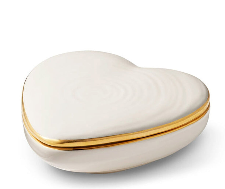 The Cream Calinda Heart Box by Aerin is a white, heart-shaped ceramic box with gold detailing on the lid, shown against a plain white background.